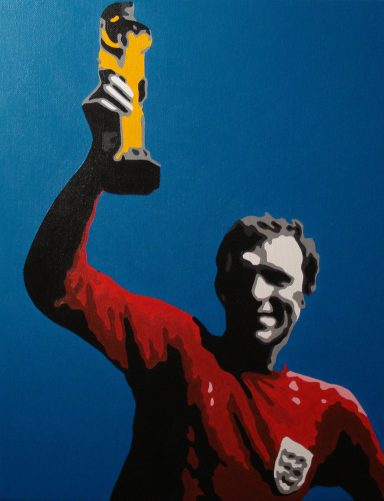 A man in a red jersey holds a golden football trophy aloft against a blue background.