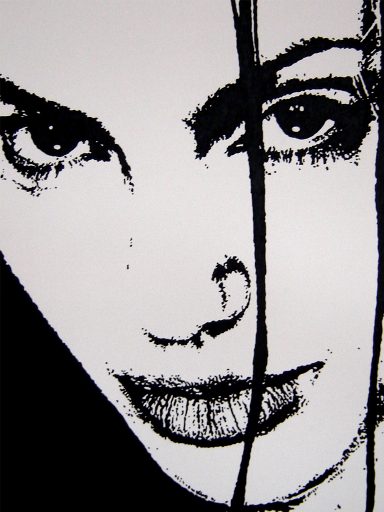 Close-up of a woman's face with striking features and bold lines in black and white.