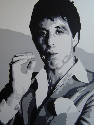 Black and white portrait of a man in a suit, holding a cigarette.